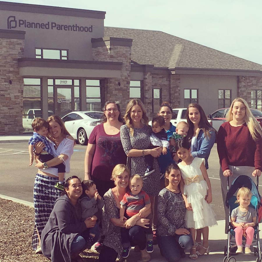 Brandi Swindell (center) with eight moms and their babies they rescued from abortion.