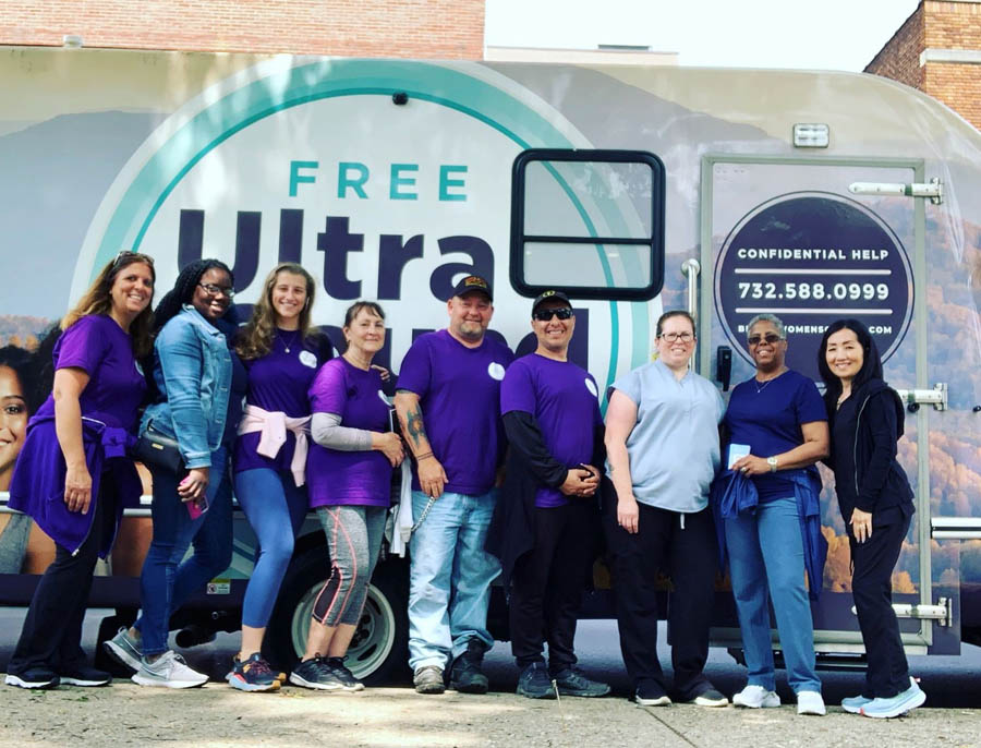 Bridge Women's Center staff and volunteers with one of the center's mobile units