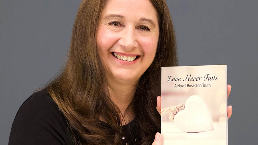 Ohio author Tesa Strasser with her book, Love Never Fails: A Novel Based on Truth
