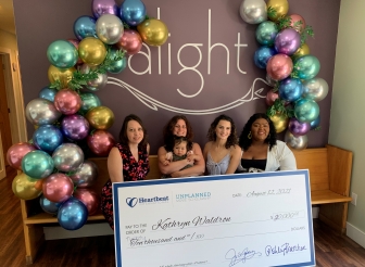 Michelle holds granddaughter Mariana, with Alight Center Executive Director Jennifer Lawlor, Katy and Alight&#039;s Client Services Director Akeria 