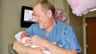 An OB/GYN for over two decades, Dr. Brent Boles holds a child he delivered. Boles has been involved in recent statewide efforts in Tennessee to protect women and children from the abortion industry.